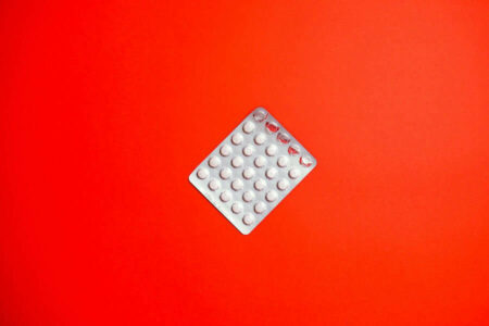 Silver blister pack of aspirin, representing the topic of aspirin's impact on stomach health.